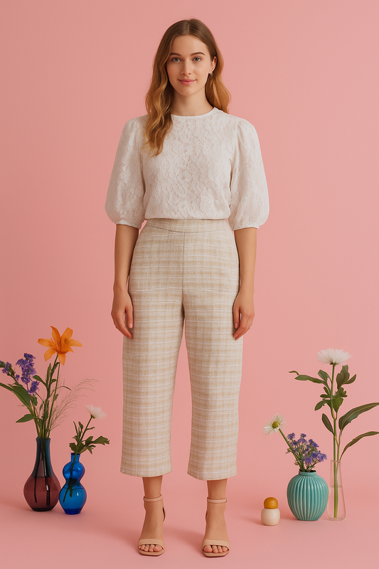 Beige tweed cropped trousers with a tailored fit, styled with a white lace blouse.