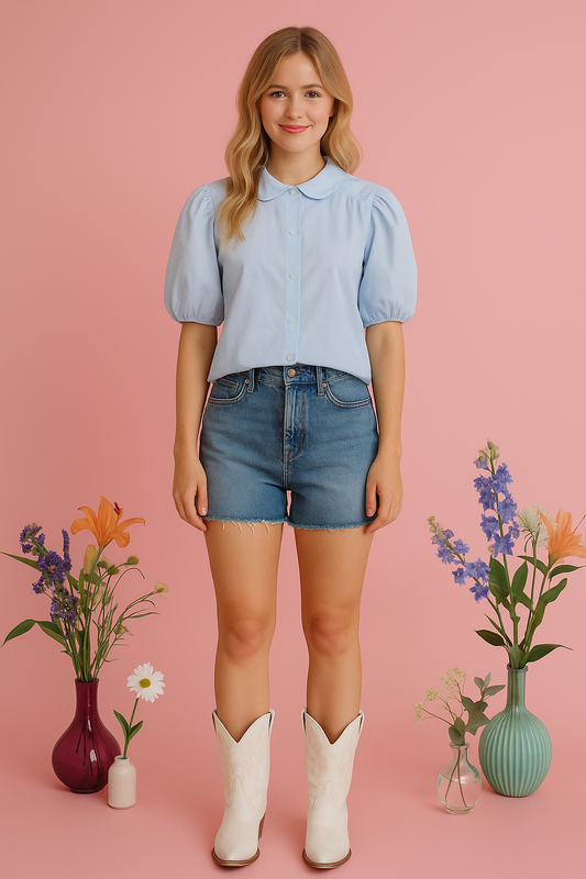 White puff-sleeve button-up blouse with tailored collar and whimsical sleeves against a pink background.